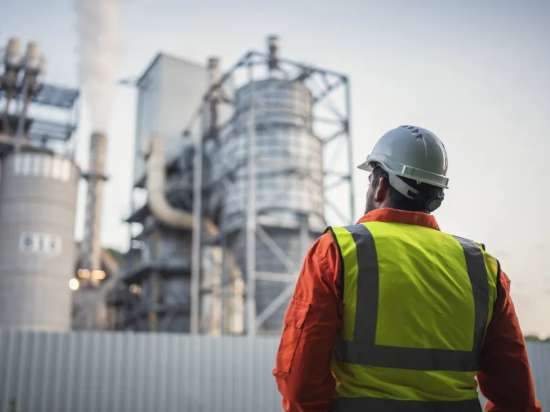 Image of a worker looking at an industrial site